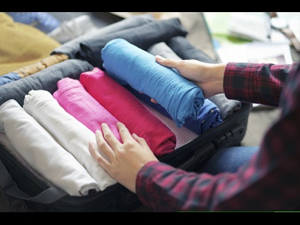 Woman packing suitcase 