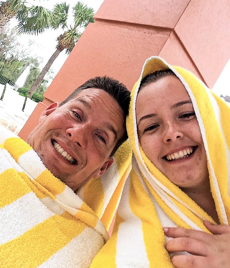 Young couple on vacation at the Hilton Grand Vacations at SeaWorld resort pool in Orlando, Florida. 