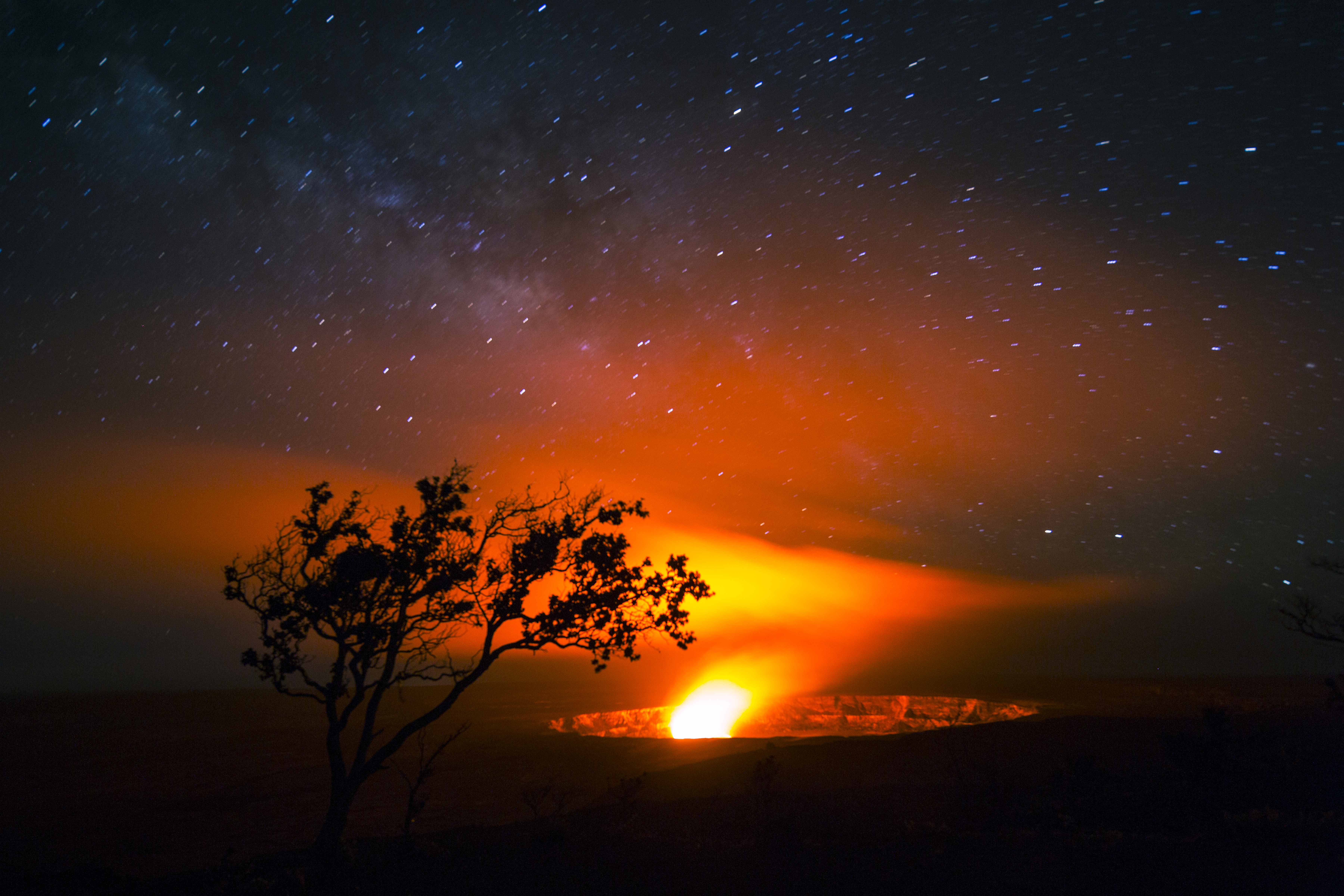 Fire from a volcano against starry night sky at Hawaii Volcanoes National Park. 