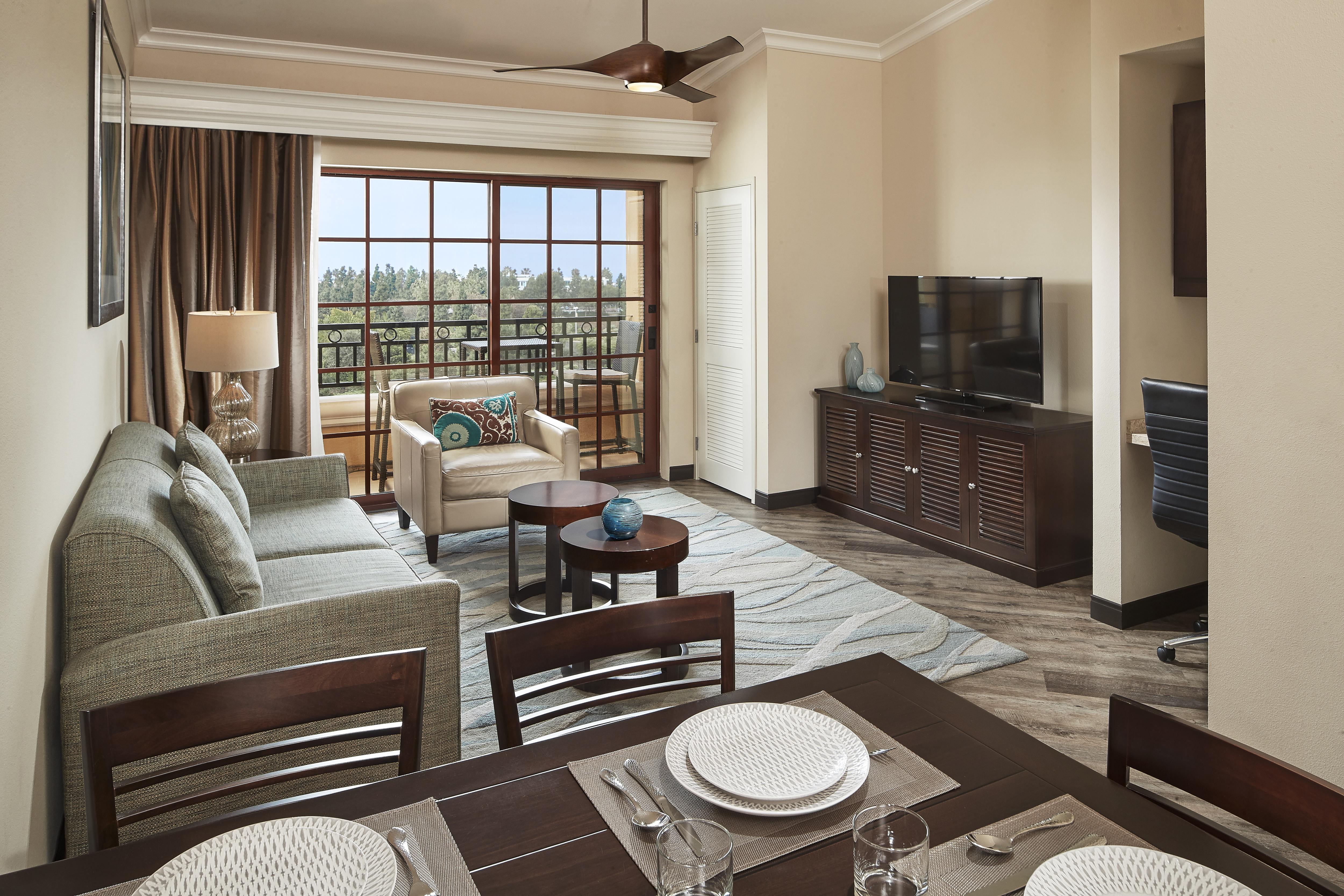 Hilton Grand Vacations suite interior, including dinning space, living room and balcony. 