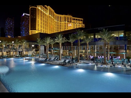 Swimming pool lit up for a night swim at Elara, a Hilton Grand Vacations Club in Las Vegas, Nevada. 