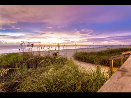 Shot of sand dunes against purple painted skies at St. Augustine Beach, Florida. 