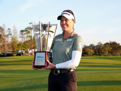 LPGA player Brooke Henderson holds up the Hilton Grand Vacations Tournament of Champions trophy
