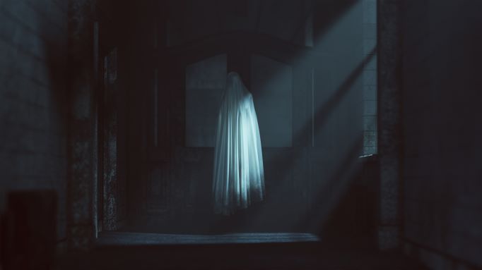Spooky scene inside an eerily lit room and a floating sheet. 