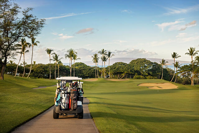 Golf cart and course set amidst gorgeous Hawaiian vista, Grand Wailea Maui, a Waldorf Asortia Resort. 