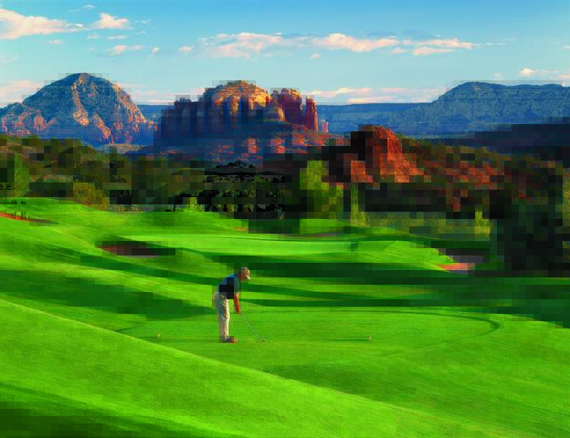 Stunning panorama of man golfing on sprawling course with a Red Rock Country backdrop, Hilton Sedona Resort at Bell Rock, Airzona. 