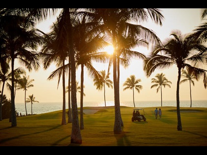 Stunning view of a Big Island golf course dotted with Palm Trees and sweeping ocean views, Kings' Land, a Hilton Grand Vacations Club, Hawaii.