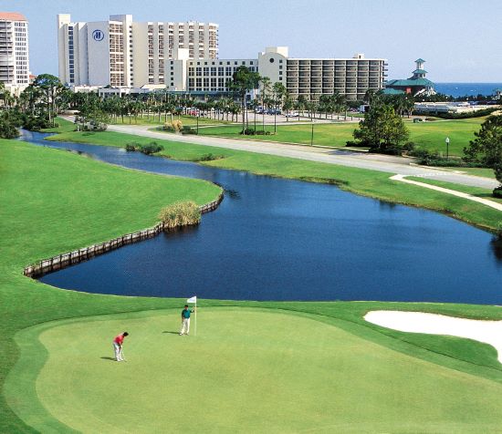 Idyllic golf scene, golfers on course, beach in the distance, Sandestin, Florida. 