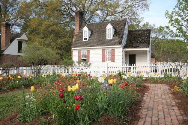 A colonial-style building with tulips in spring in historic Williamsburg, Virginia. 