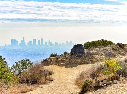 A hiking trail with a view of the Los Angeles, California skyline