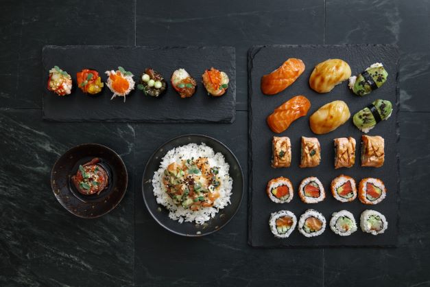 High-end sushi, overhead shot, black tablecloth. 