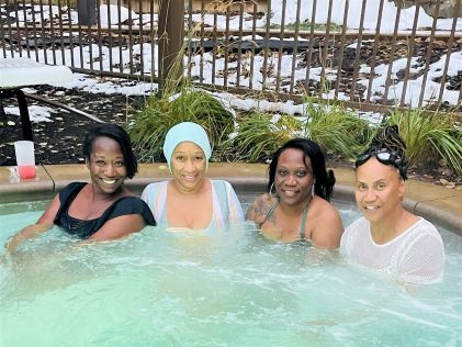A Hilton Grand Vacations Owner and her guests in the hot tub at Sunrise Lodge, a Hilton Grand Vacations Club, in Park City, Utah