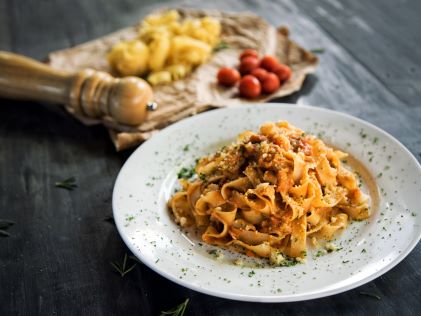 A bowl of pasta on a wooden table