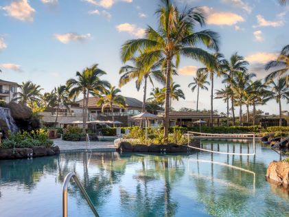 Palm tree-lined pool designed for environmental sustainability at Maui Bay Villas, a Hilton Grand Vacations Club