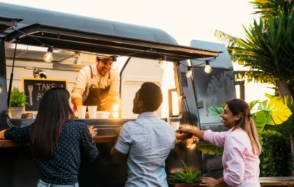 Group of people, happily ordering food, food truck. 