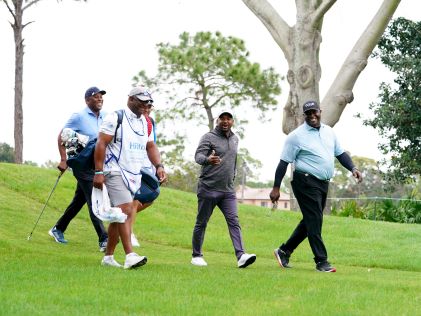Celebrities walking the green at the Hilton Grand Vacations Tournament of Champions