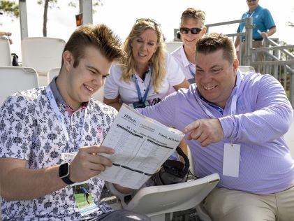 Spectators consult the tee sheet at the Hilton Grand Vacations Tournament of Champions