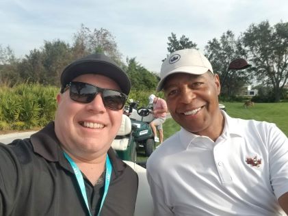 A Hilton Grand Vacations Member takes a selfie with Marcus Allen at the Hilton Grand Vacations Tournament of Champions