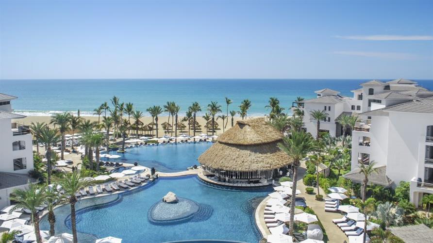 Pool and palm trees at Cabo Azul, a Hilton Vacation Club, plus a view of the beach