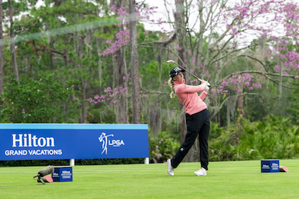 An LPGA golfer swings a golf club from a tee box at the Hilton Grand Vacations Tournament of Champions