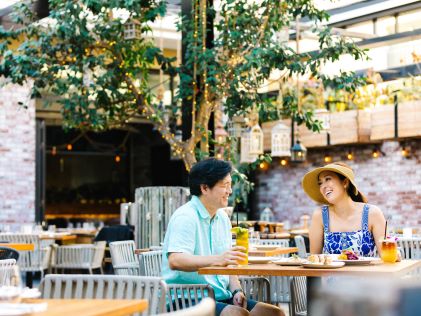 A couple shares a meal outdoor in Oahu, Hawaii