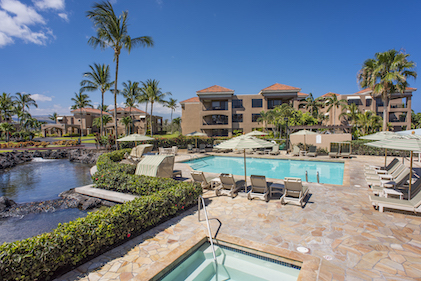 View of the manicured grounds, outdoor pool, hot tub and cabanas at The Bay Club, a Hilton Grand Vacations Club, Waikoloa, Hawaii