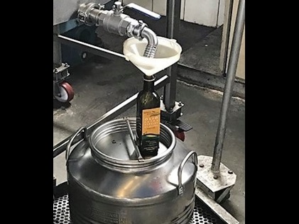 A bottle of authentic olive oil being processed in Tuscany, Italy