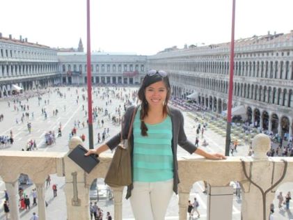 A Hilton Grand Vacations Member posing in front of St. Mark's Square in Venice, Italy