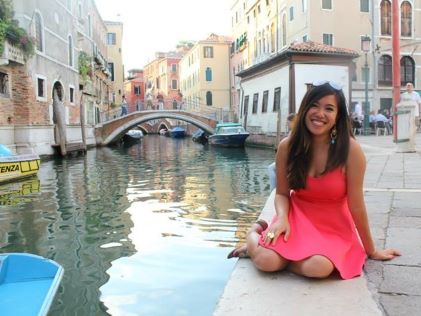 A Hilton Grand Vacations Member sitting by a canal in Venice, Italy