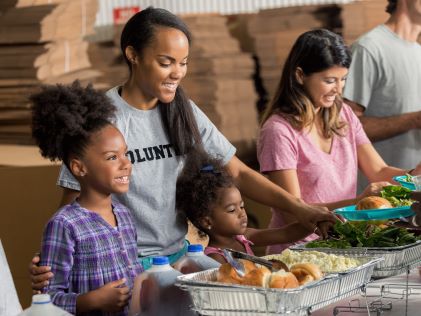 A family volunteering at a soup kitchen