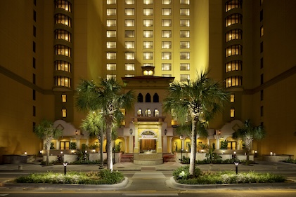 Nighttime image spanning upward from of the entrance to Anderson Ocean Club, a Hilton Grand Vacations property in Myrtle Beach, South Carolina
