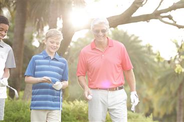 Grandfather and grandson golfing.